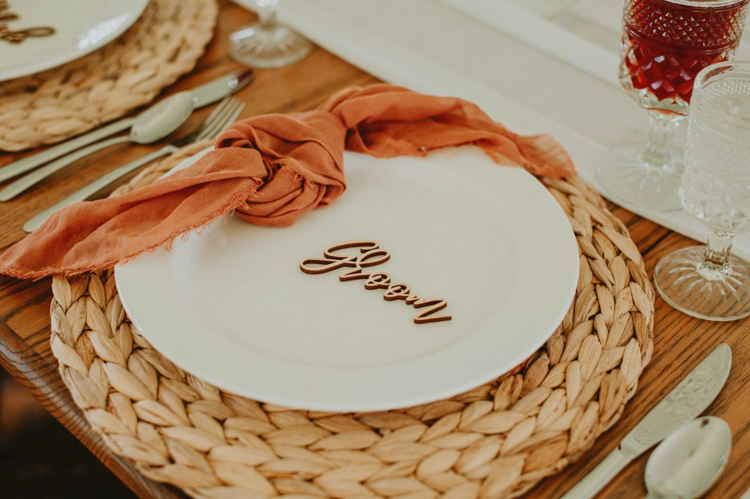 A folded napkin rests on a plate on a table, a small object signaling how the seat should be used.