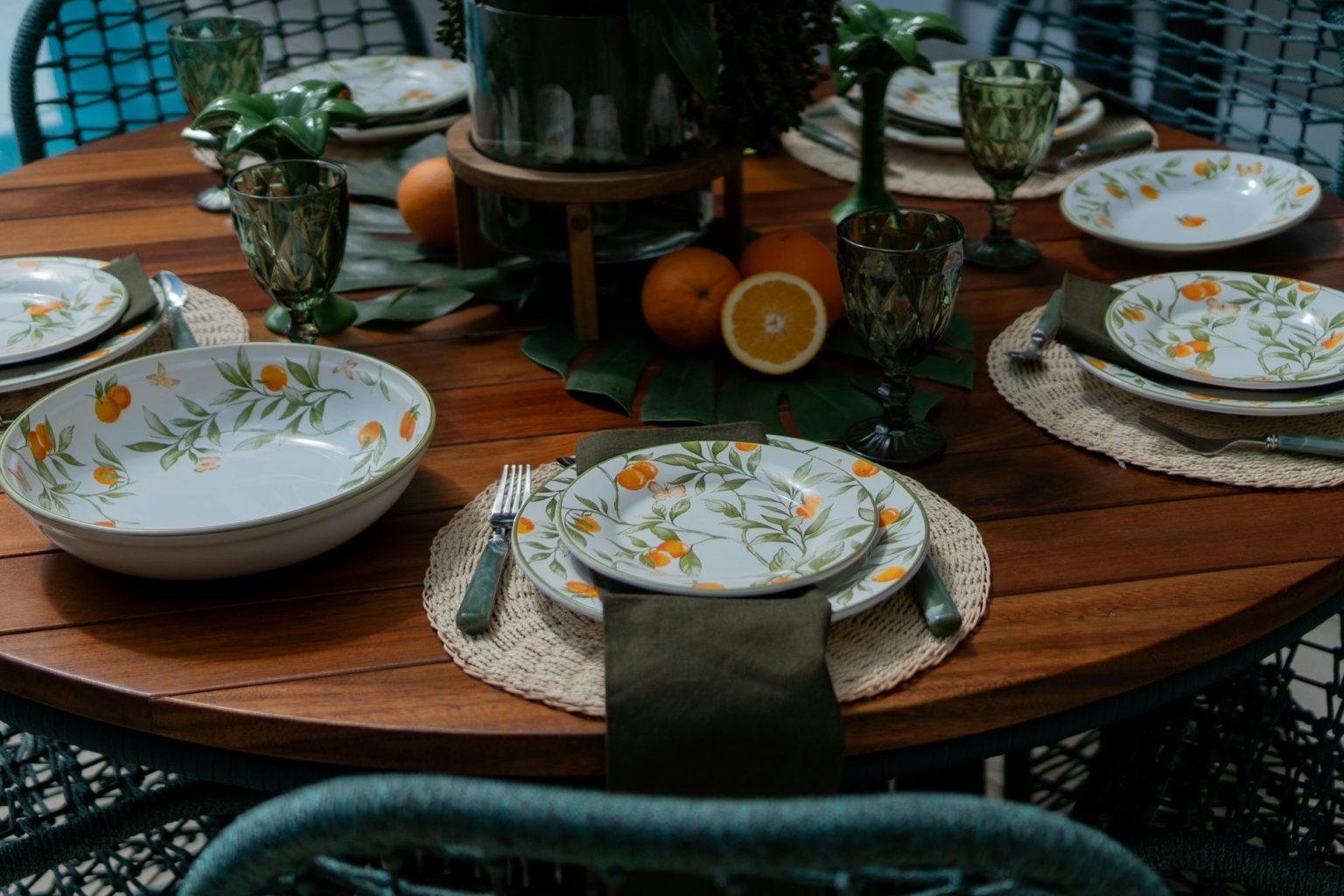A wooden table is topped with an assortment of plates and bowls in a simple, lived-in arrangement.
